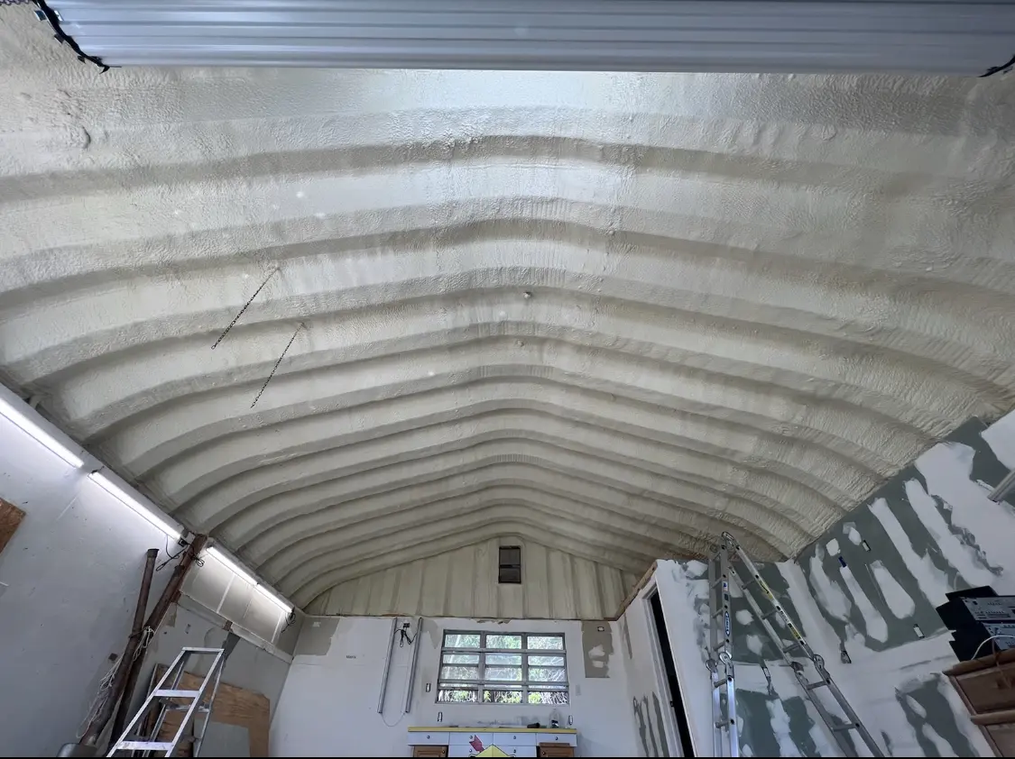 Spray polyurethane foam applied to the underside of a metal roof deck in Gardere